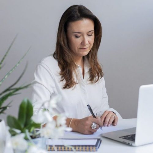 Dr Kamila Hortynska writing in a peaceful minimal environment